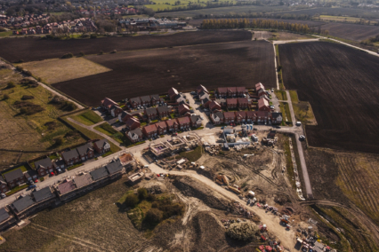 Aerial view of a residential development site with houses and construction activity.