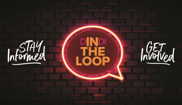 Neon sign featuring a speech bubble with the text 'DINDI THE LOOP' in orange on a dark brick background.